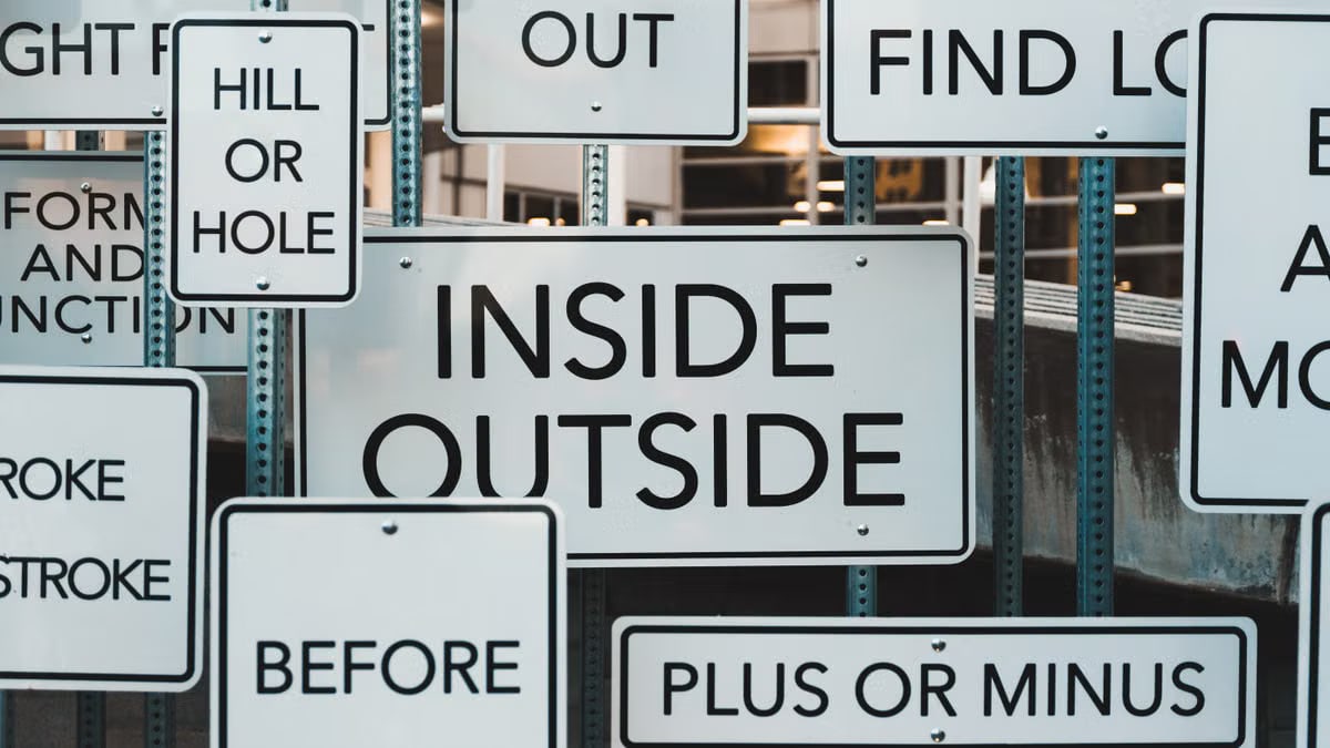 A creative display of street signs in Salt Lake City, showcasing contrasting messages and typography.